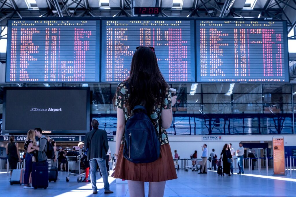 In an airport looking for her flight